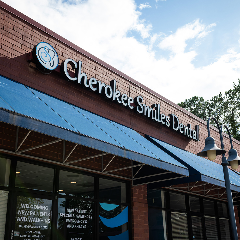 The image shows a storefront with a sign that reads Cheocreek Smiles Dental.
